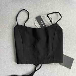 Black tank crop top with back detail and back tie, never worn, thick material
